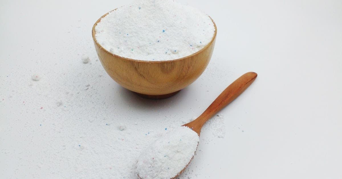 Baking soda in a wooden bowl with a wooden spoon
