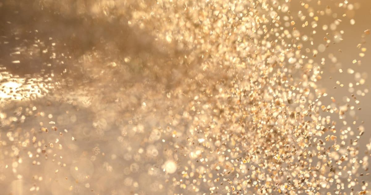 Fine dust particles suspended in a beam of warm light
